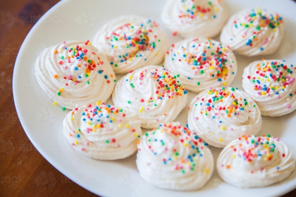 Meringues with sprinkles on a plate - Australian Stock Image