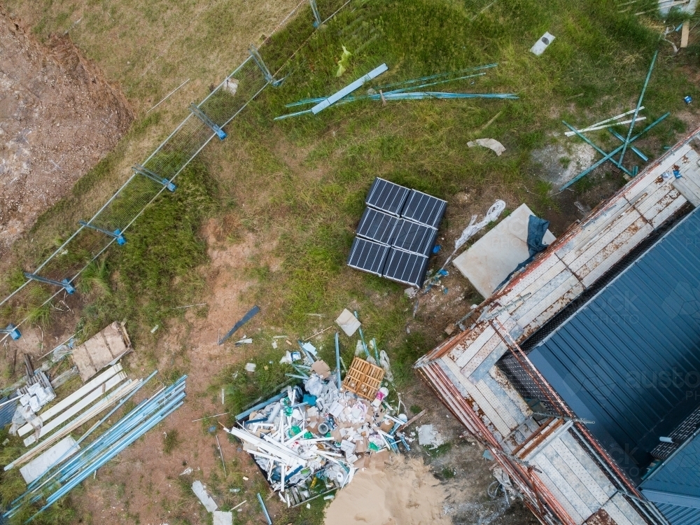 Messy construction worksite with scaffolding around house - Australian Stock Image