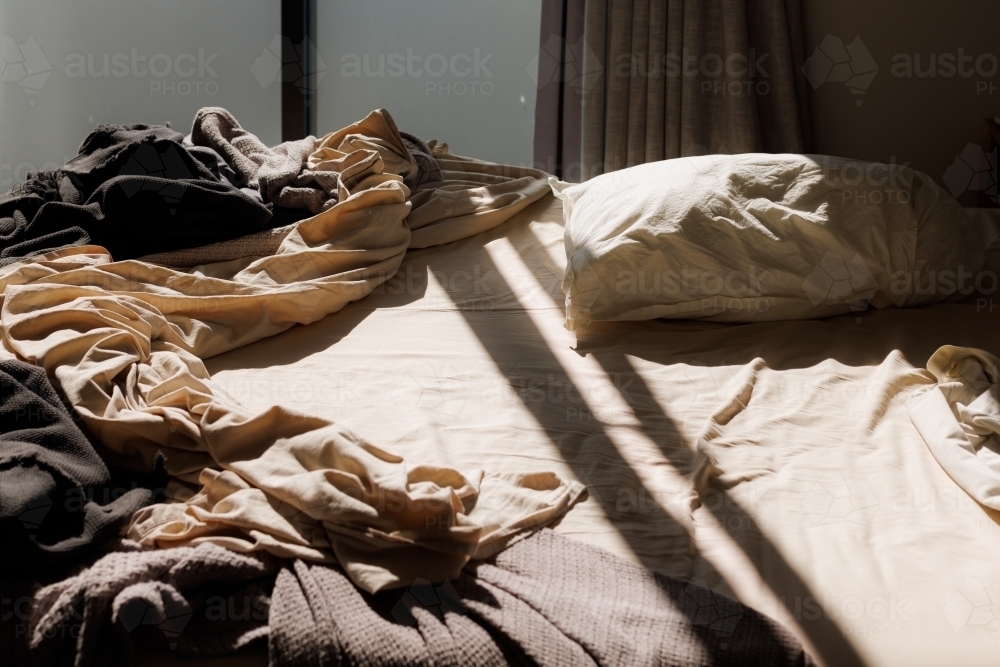 Lessy Bed Image of Messy unmade bed in the early morning - Austockphoto