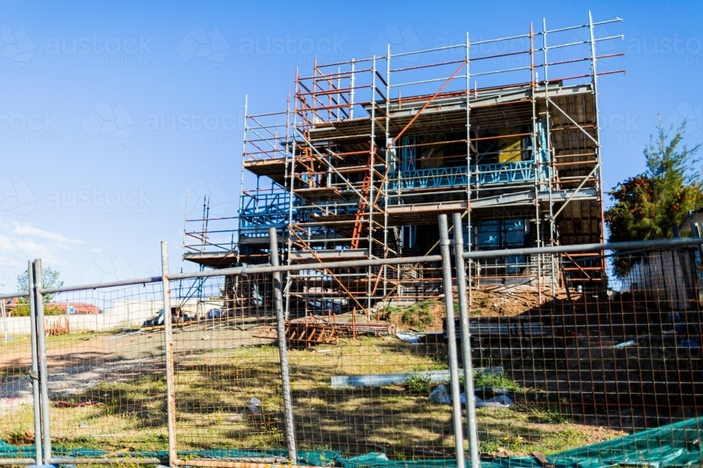Metal scaffolding surrounding house build construction site - Australian Stock Image