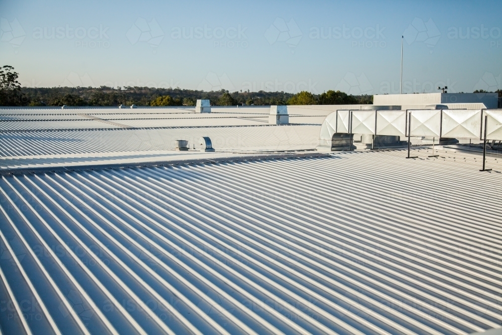 Metallic roof with vents shining in the sunlight - Australian Stock Image