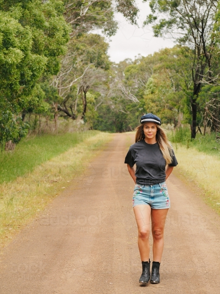 Mid twenties country girl walking down a bush track. - Australian Stock Image