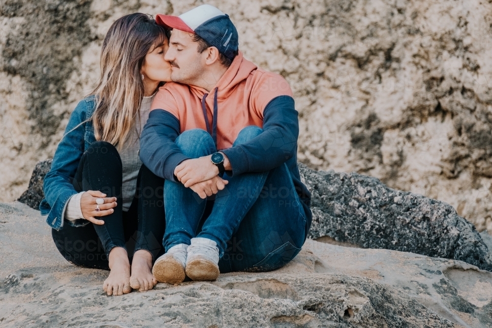 Mid twenties couple kiss. - Australian Stock Image
