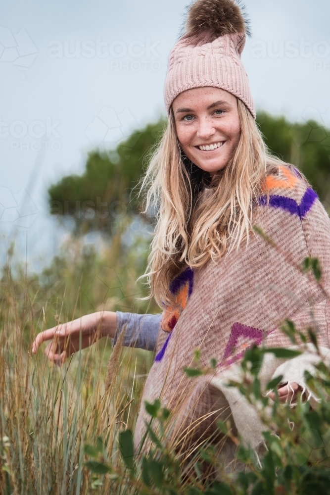 Mid twenties woman dressed in warm winter clothes outdoors. - Australian Stock Image