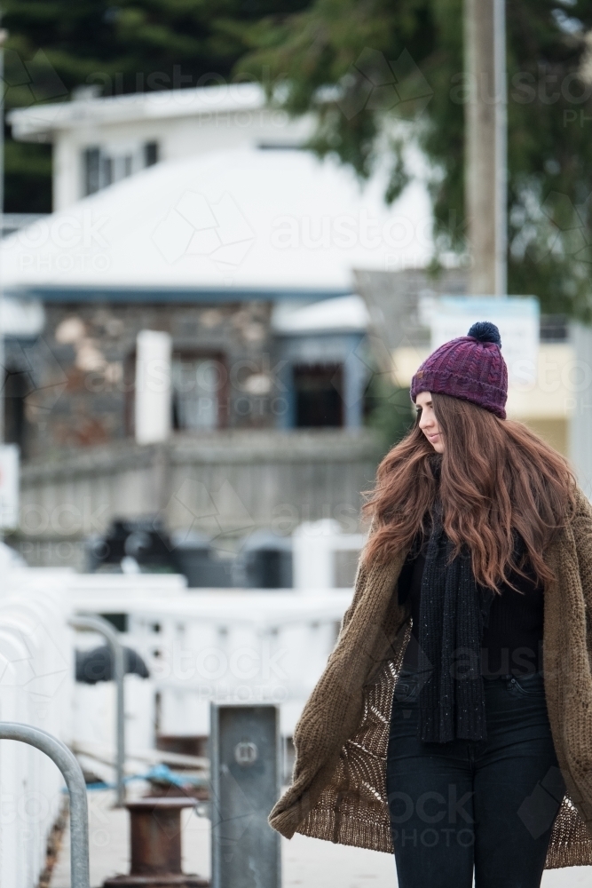 Mid twenties woman walking in winter clothes. - Australian Stock Image