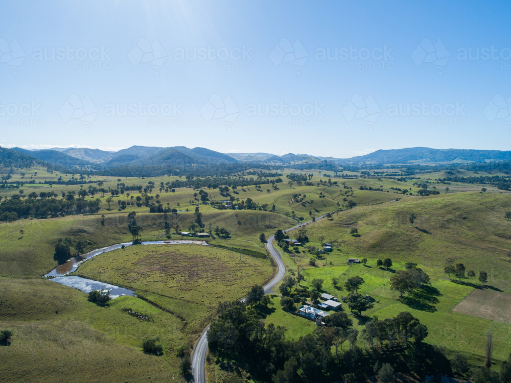midday aerial landscape view of green country paddocks under clear blue sky in Hunter Valley - Australian Stock Image