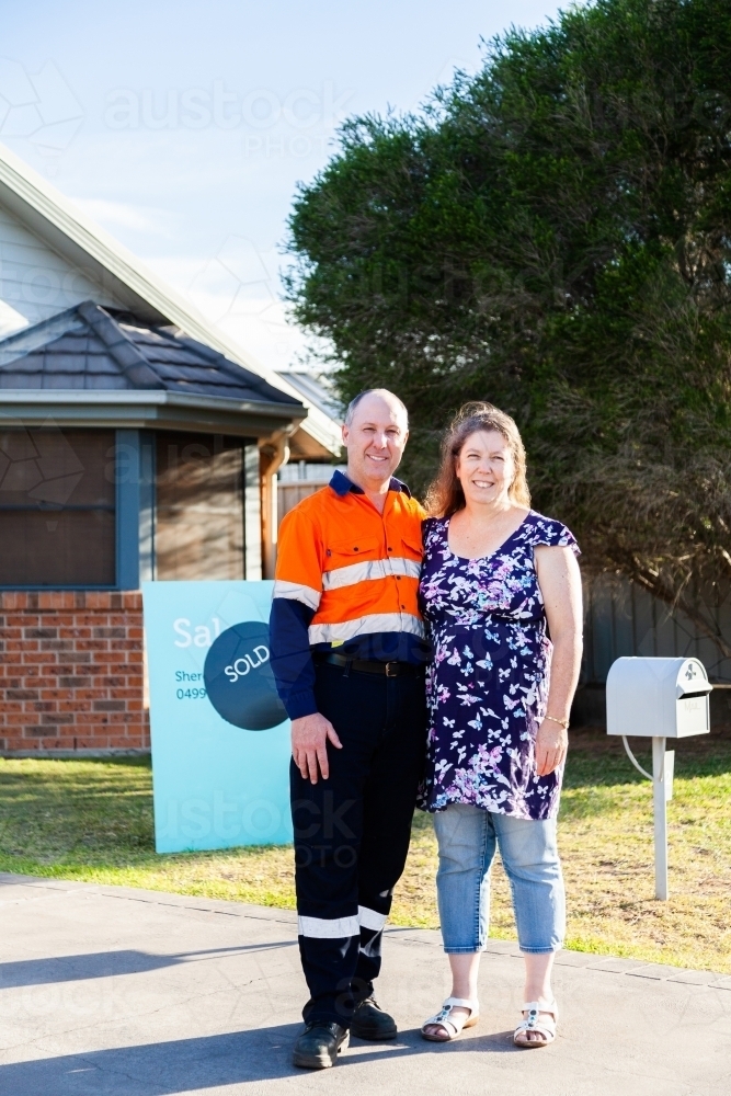 Middle aged couple buying first investment property - sold real estate - Australian Stock Image
