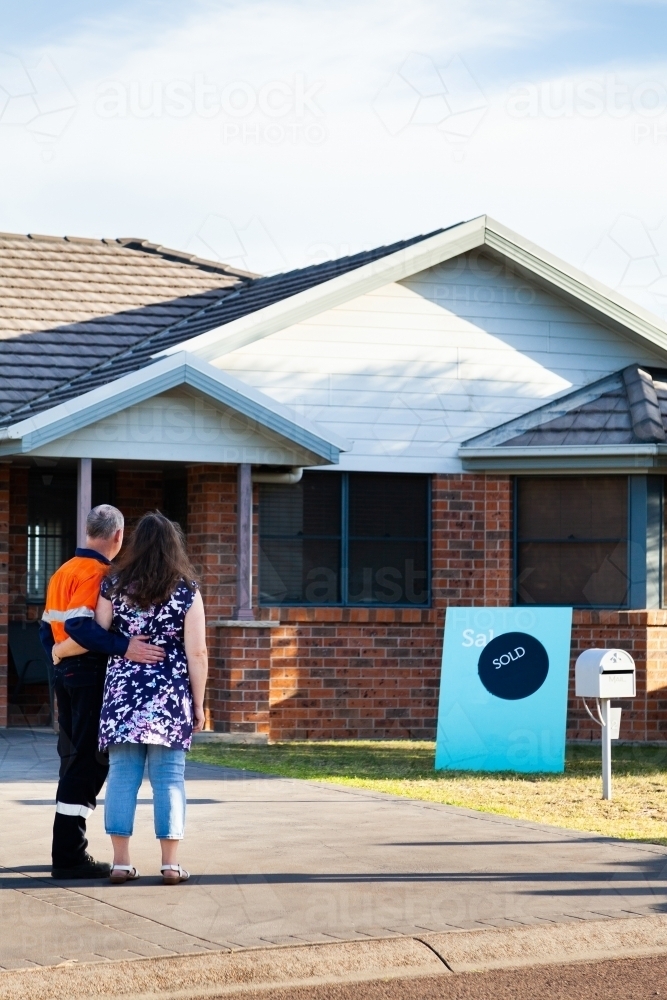 Middle aged couple buying first investment property - sold real estate - Australian Stock Image