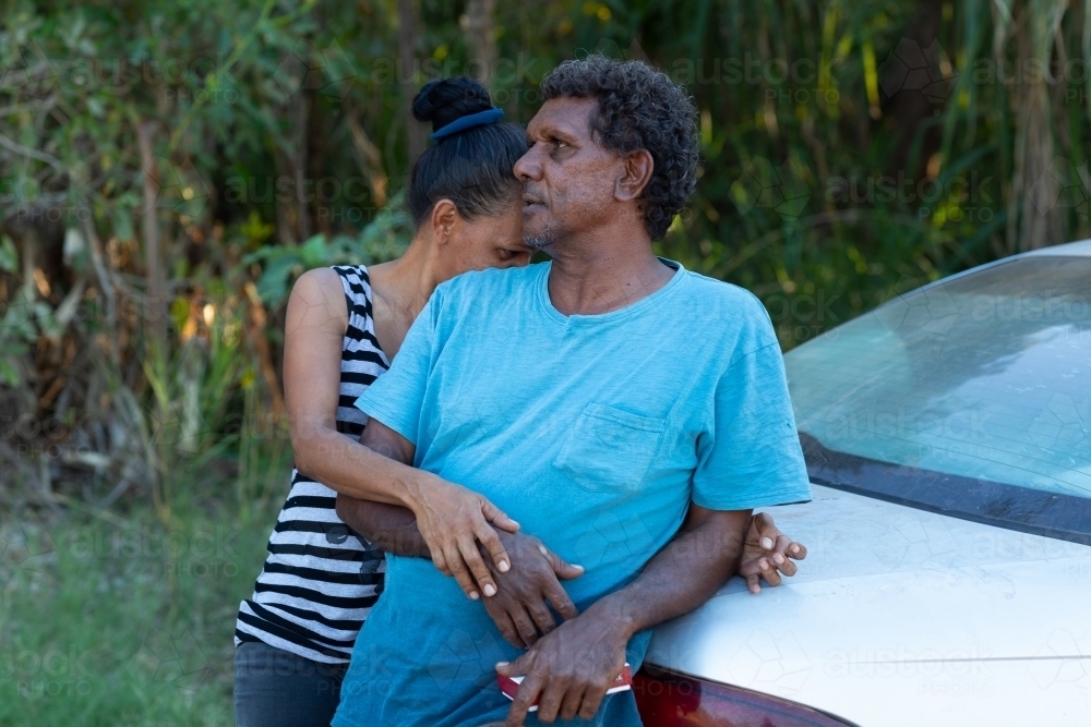 middle-aged couple leaning on car boot - Australian Stock Image