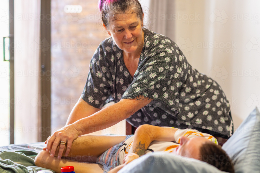 Image Of Middle aged Mum Helping His Young Son With Disability Position image-of-middle-aged-mum-helping-his-young-son-with-disability-position