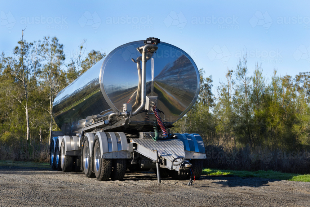 Milk tanker trailer parked up in the bush - Australian Stock Image
