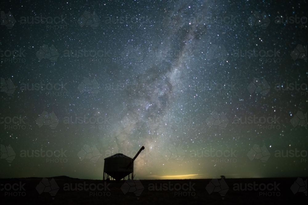 Milky Way setting behind farming containers in the Australian night sky. - Australian Stock Image