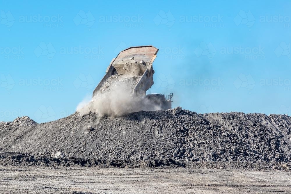 Mine dump truck dumping tailings - Australian Stock Image