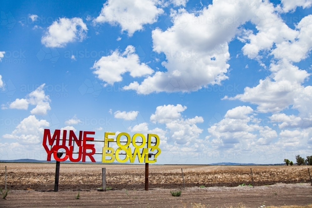 Mine your food bowl? sign on farm paddock fence - Australian Stock Image