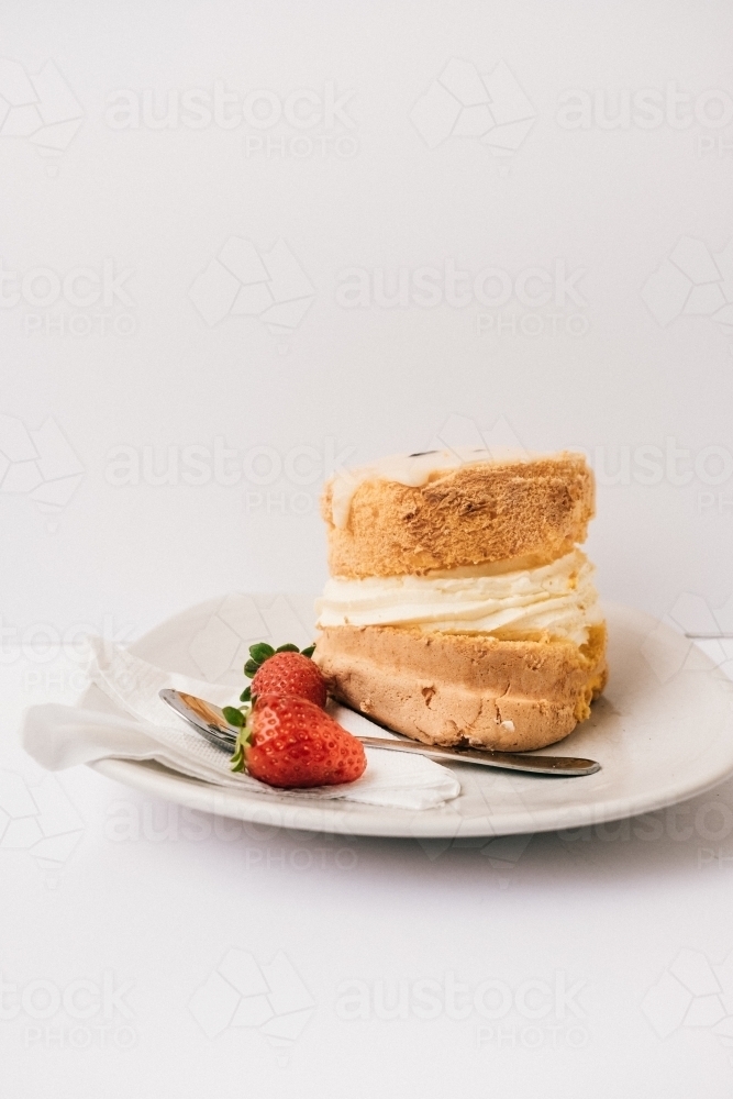 Mini passionfruit sponge cake with strawberries and cream. - Australian Stock Image