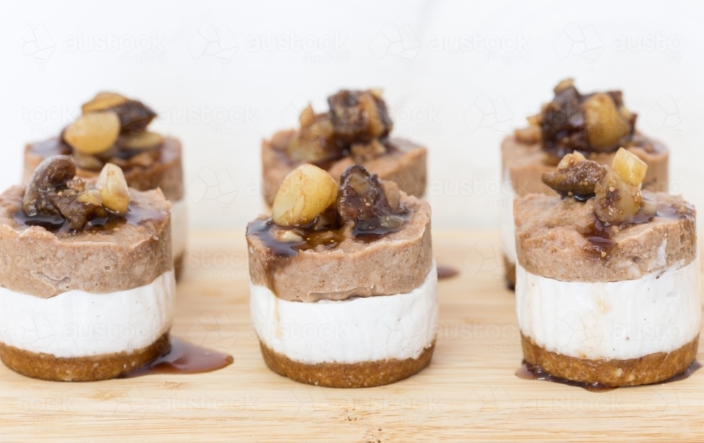 Mini raw Macadamia, choc cheesecakes served on a board - Australian Stock Image
