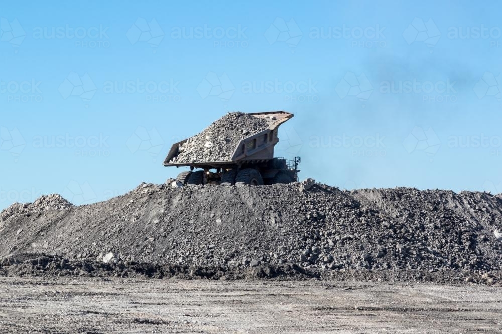 Mining dump truck dumping tailings - Australian Stock Image