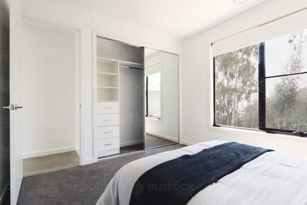 Mirrored wardrobe detail in a bedroom with a view - Australian Stock Image