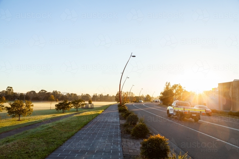 Mist and morning light as mine workers ute drives down road - Australian Stock Image