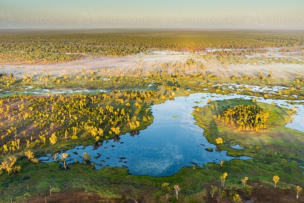 Mist rising over wetlands at sunrise - Australian Stock Image
