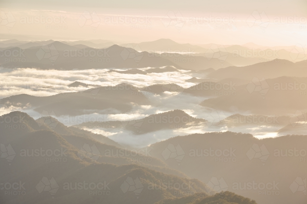 Misty mountain range during sunrise - Australian Stock Image