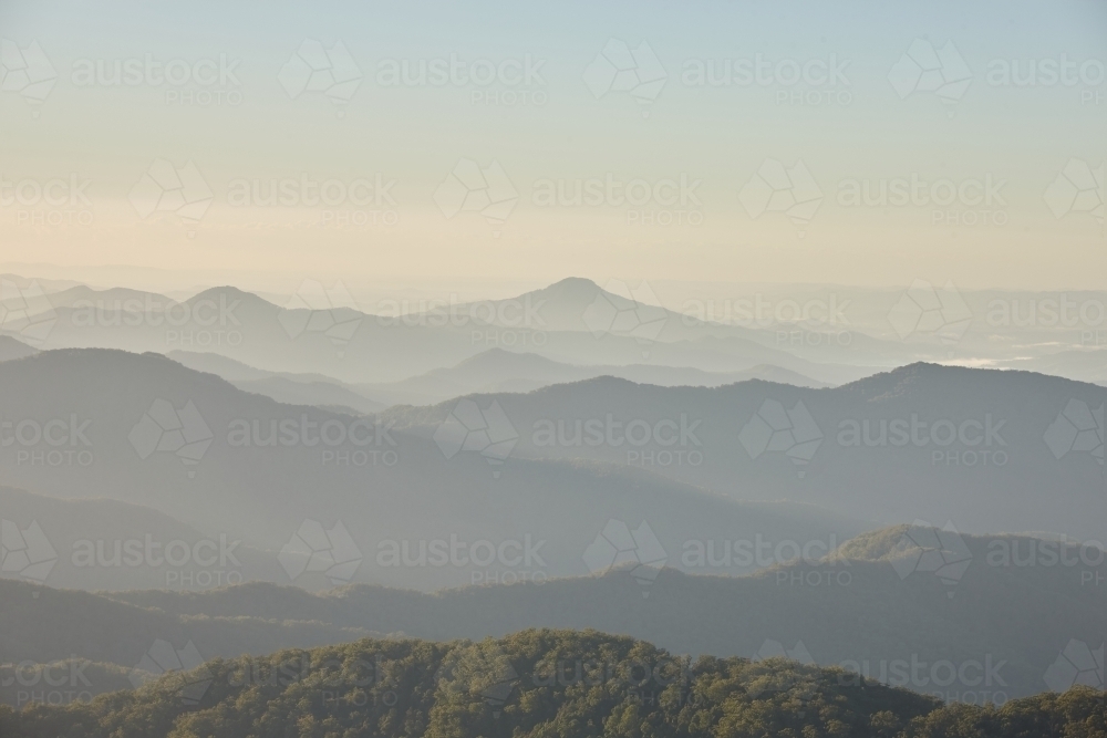 Misty mountain range during sunset - Australian Stock Image