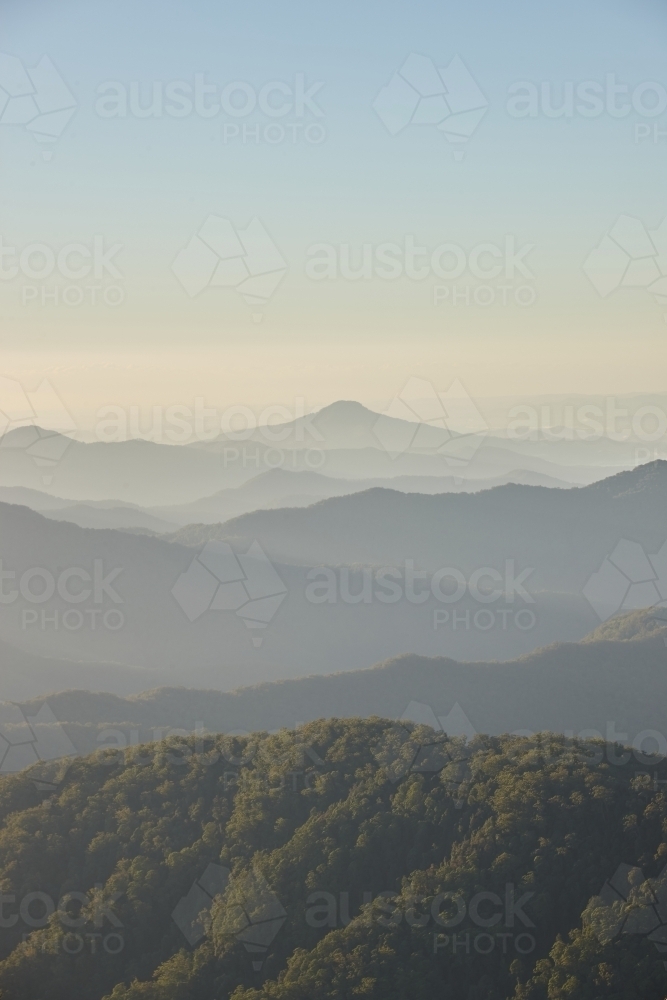 Misty mountain range during sunset - Australian Stock Image