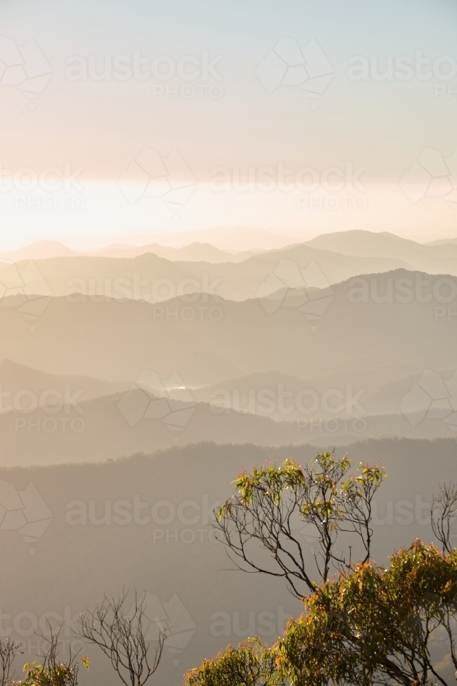Misty mountain range during sunset - Australian Stock Image