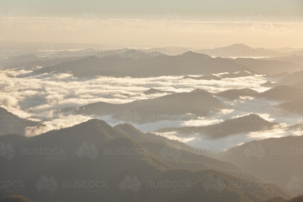 Misty mountain range during sunset - Australian Stock Image