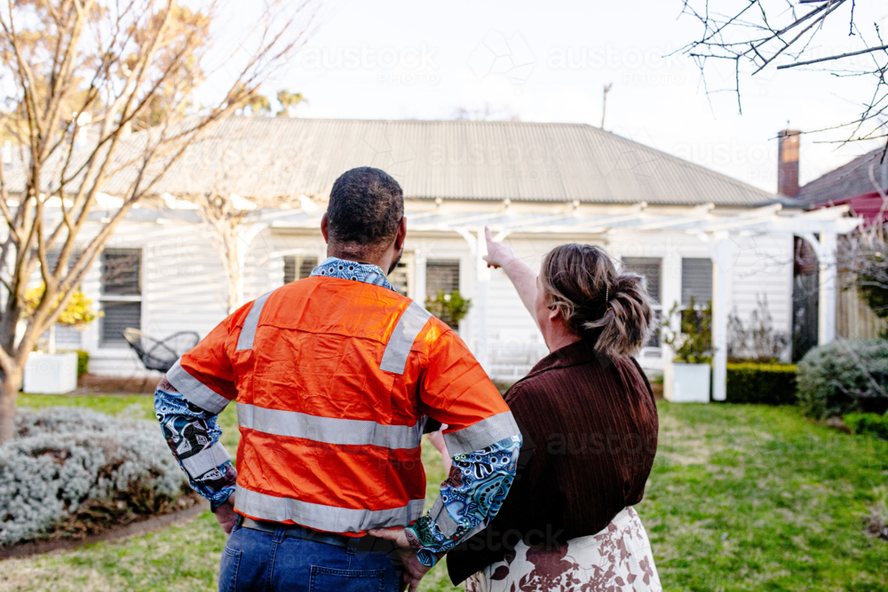 Mixed ethnicity couple planning a renovation in their backyard - Australian Stock Image