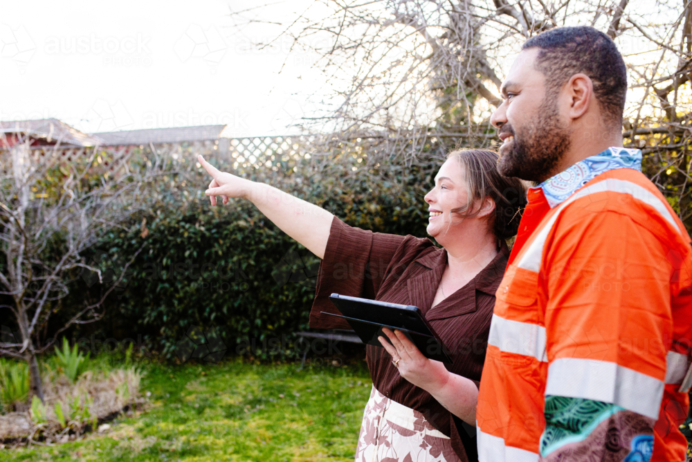 Mixed ethnicity couple planning a renovation in their backyard - Australian Stock Image