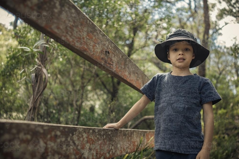Mixed race boy bushwalking wearing a hat in Barrington Tops National Park - Australian Stock Image
