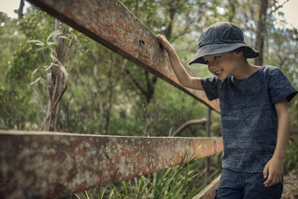 Mixed race boy bushwalking wearing a hat in Barrington Tops National Park - Australian Stock Image