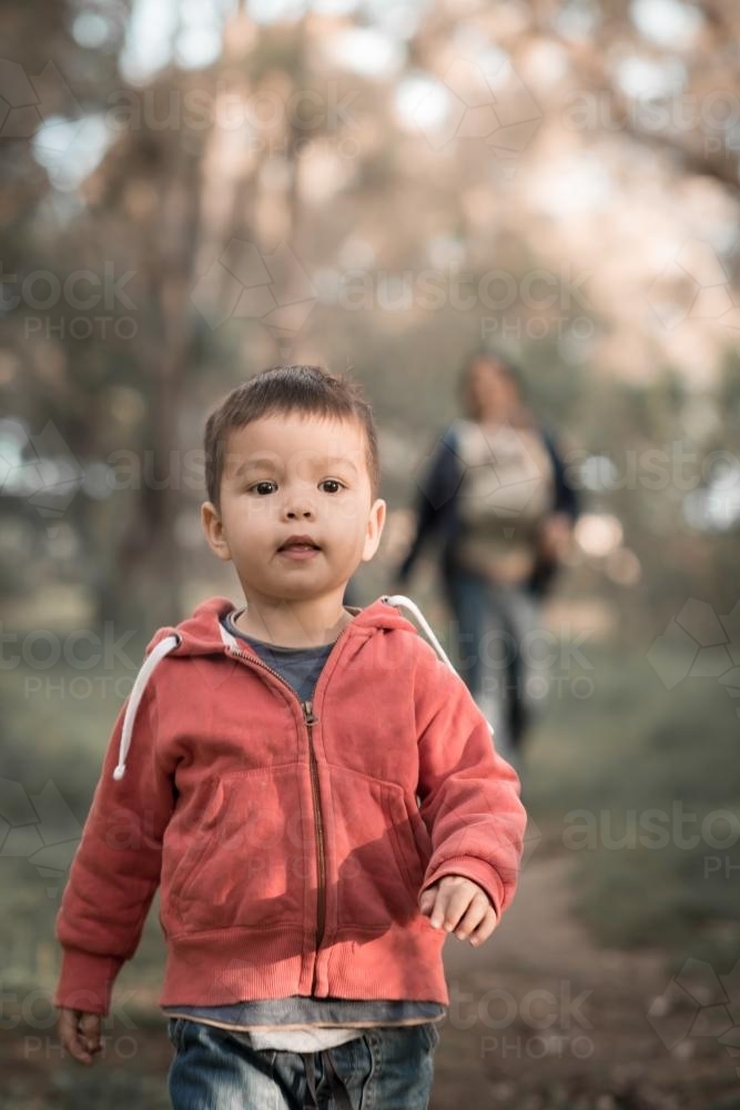 Mixed race boys walk with their Asian mother in a Sydney suburban park - Australian Stock Image