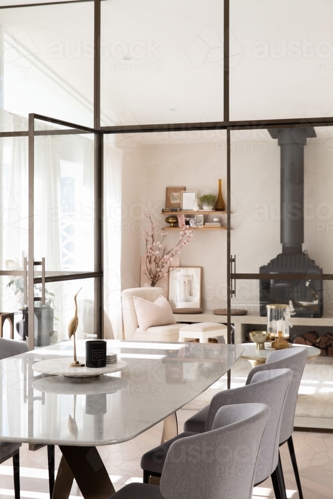 Modern charming dining and living room separated by steel door - Australian Stock Image