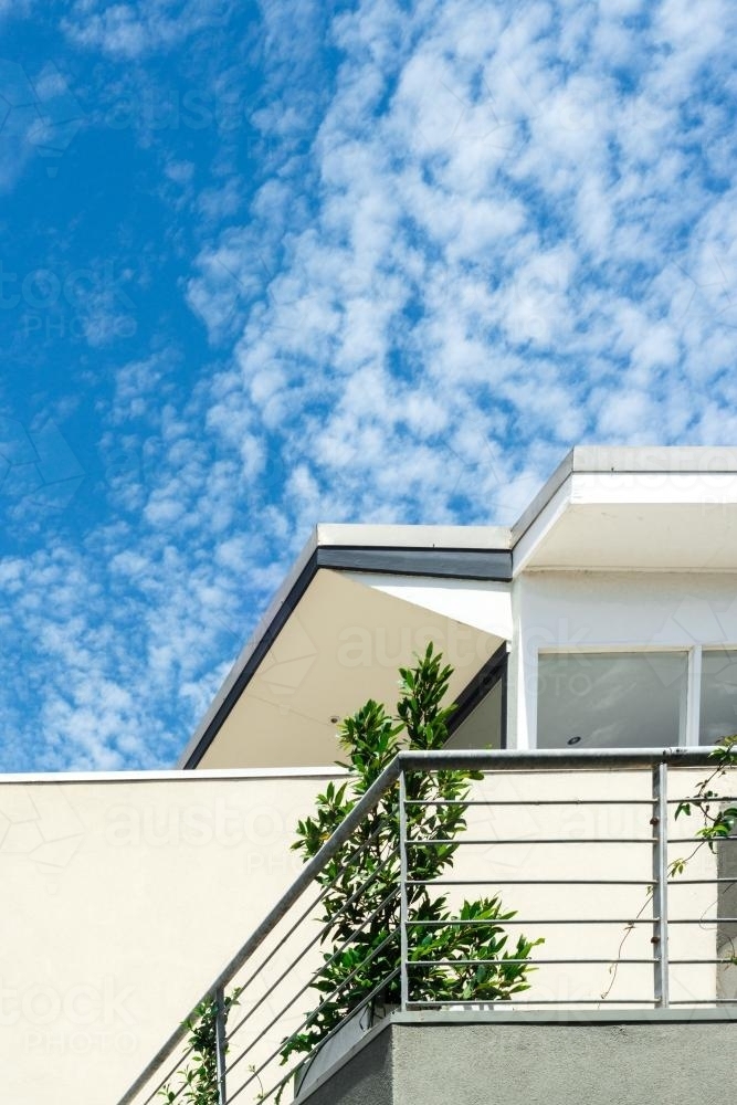 modern generic white apartment building against blue sky - Australian Stock Image