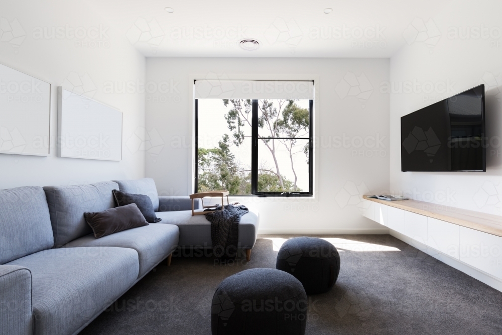 Modern living tv room in a contemporary home with gum tree outlook - Australian Stock Image