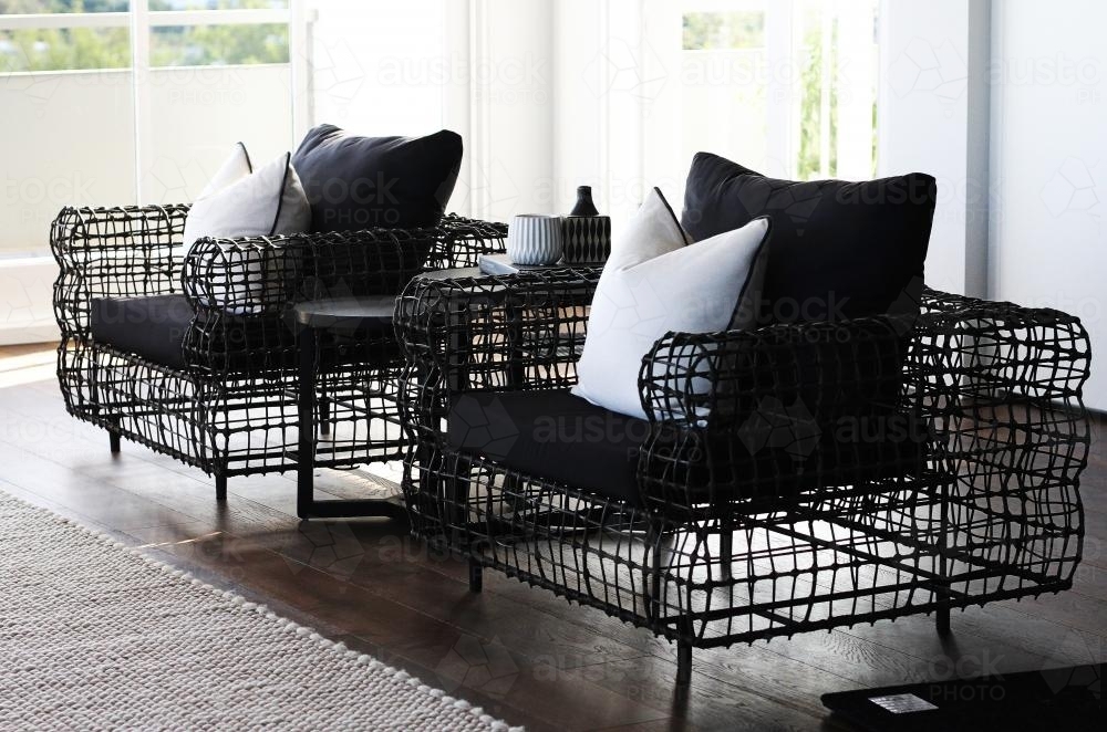 Modern lounge chairs inside a room lit with natural light - Australian Stock Image