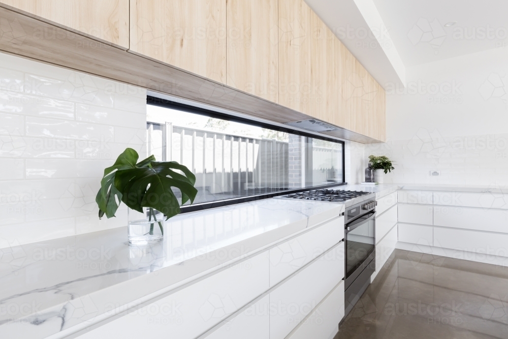 Image of Modern luxury kitchen with window splashback - Austockphoto
