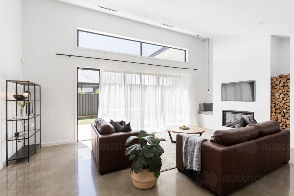 Modern open plan luxury living room with glass sliding doors - Australian Stock Image