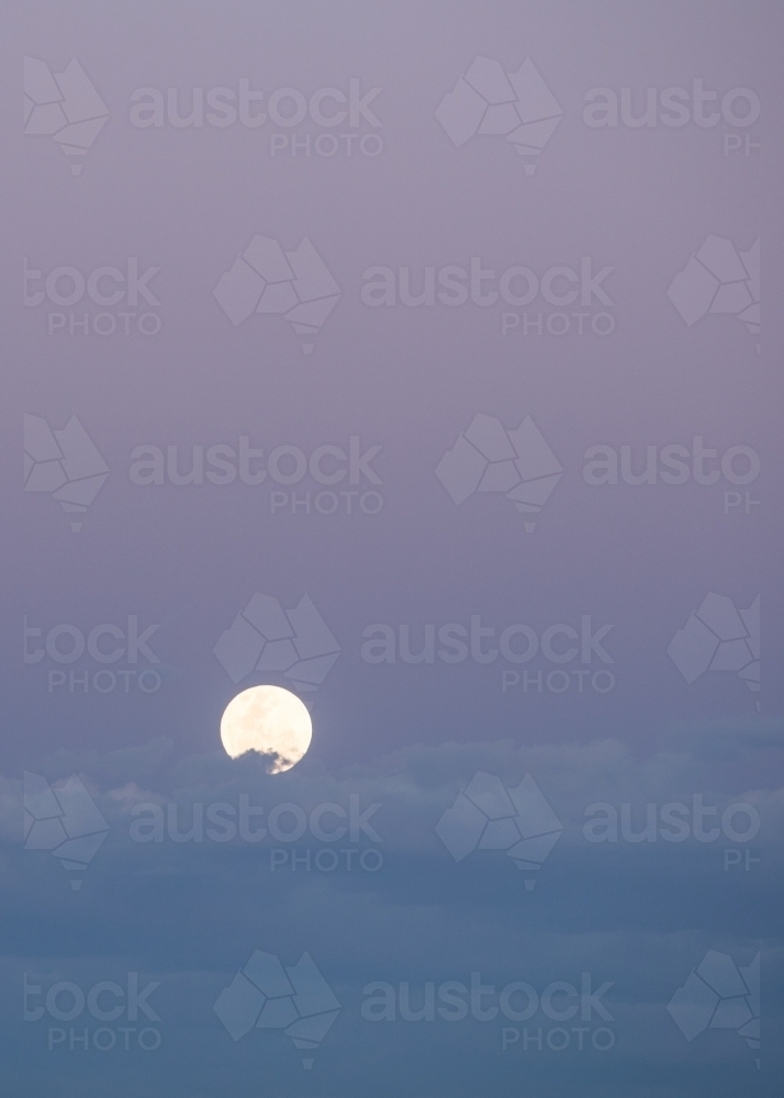 Moon in sky at dusk - Australian Stock Image