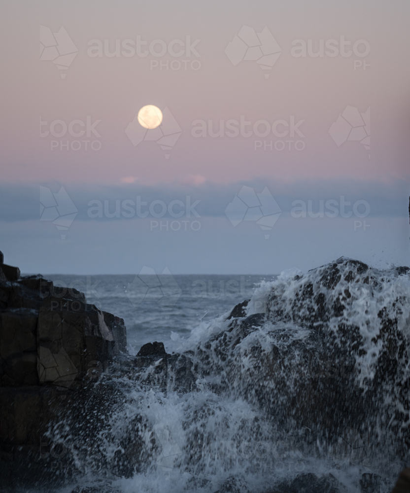 moon over sea at bombo - Australian Stock Image