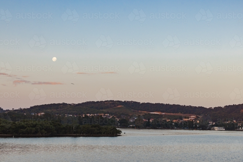 Moon rising over Lake Macquarie, NSW - Australian Stock Image