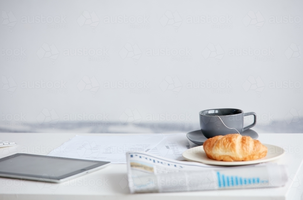 Morning breakfast and device on table - Australian Stock Image