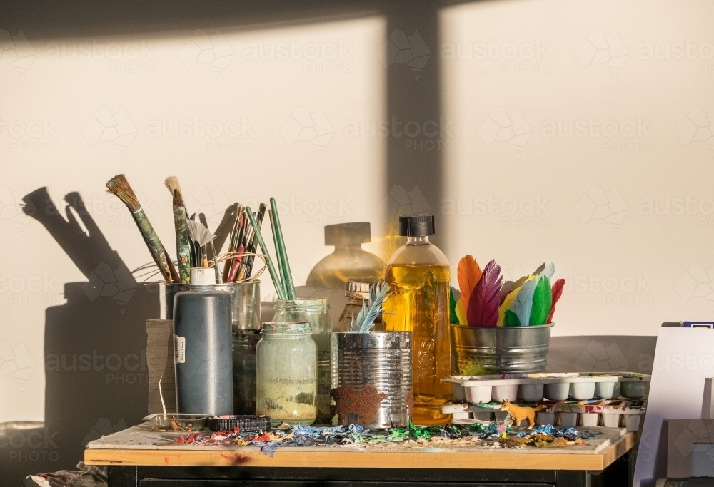 Morning light in an art studio with brushes and paint palette - Australian Stock Image