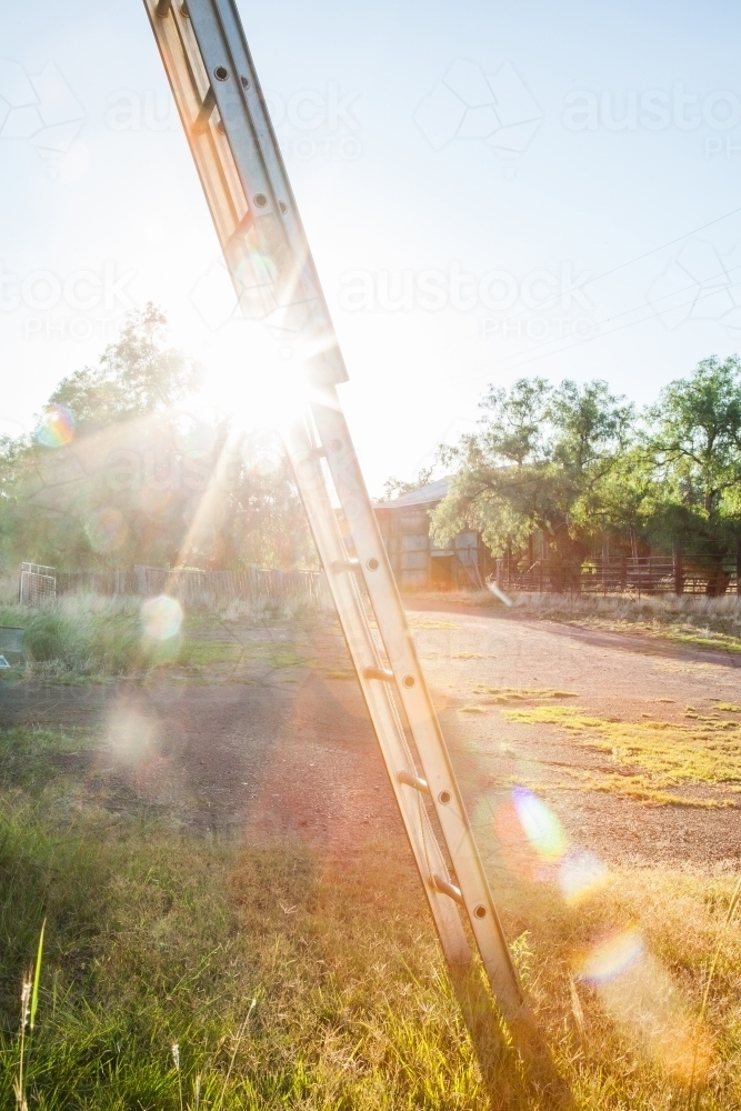 Morning sunlight shining through ladder on country farm - Australian Stock Image