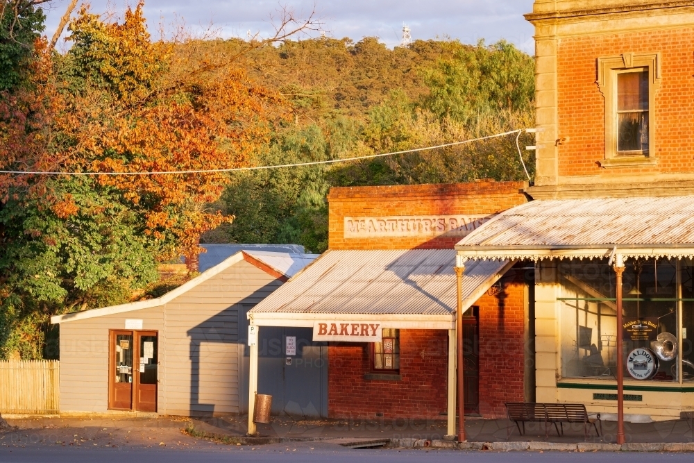 Morning sunshine on old shopfronts in rural streetscape - Australian Stock Image