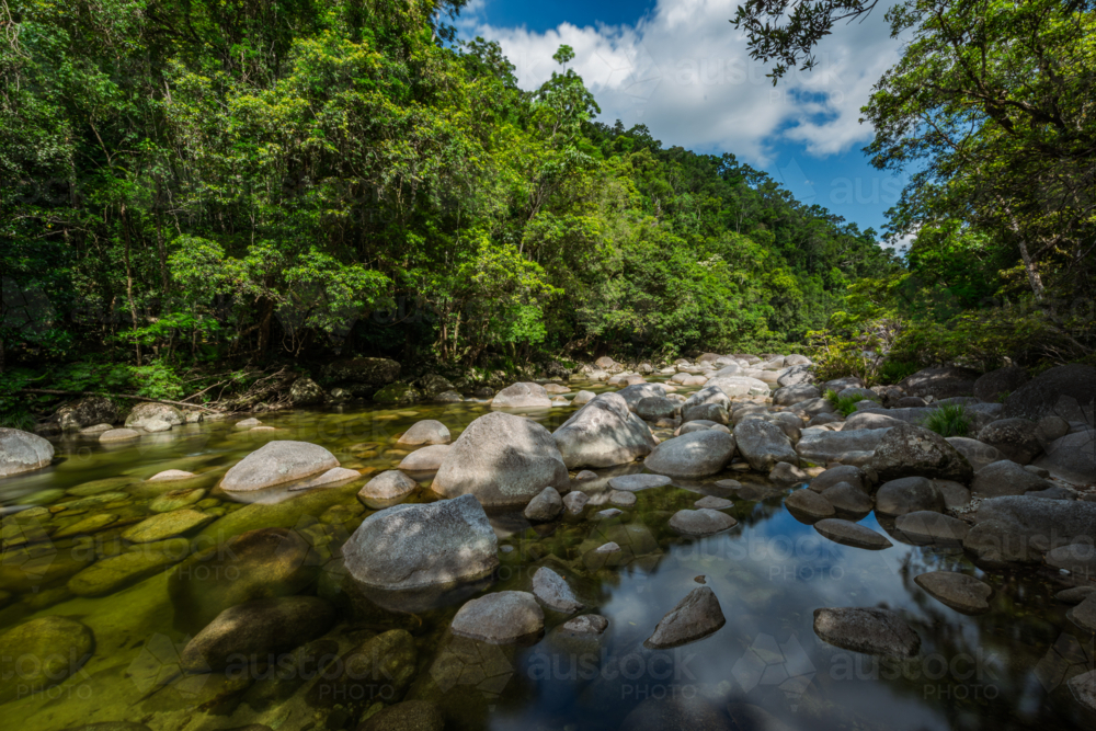 Mossman river flowing amongst the boulders at Mossman Gorge - Australian Stock Image