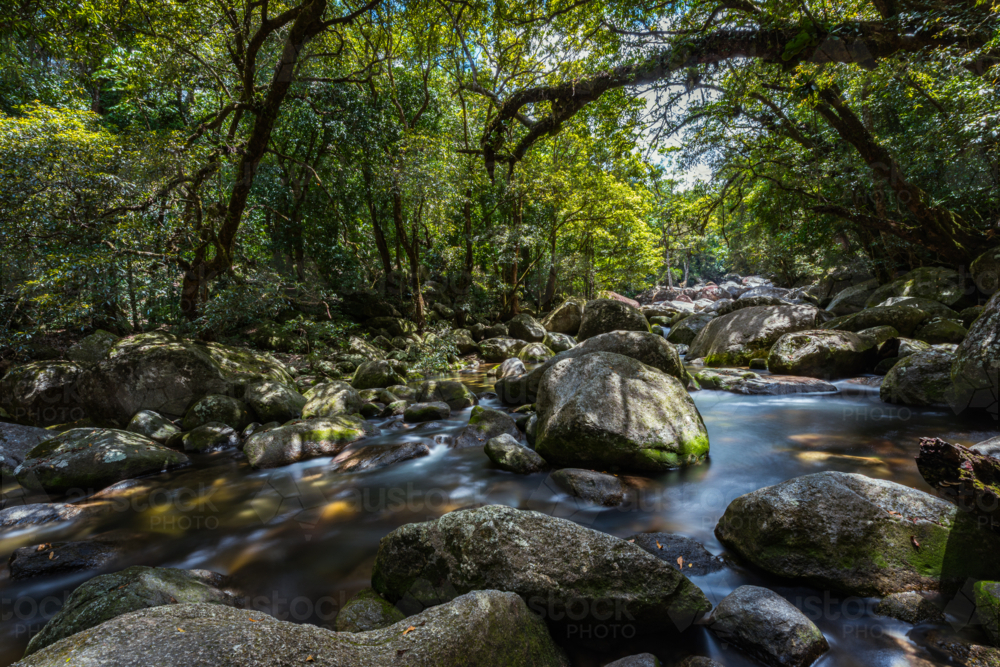 Mossman river flowing amongst the boulders at Mossman Gorge - Australian Stock Image