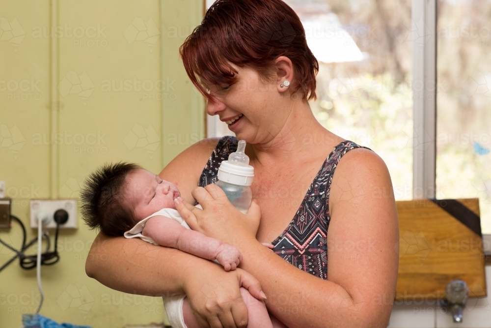 Mother and baby with bottle - Australian Stock Image